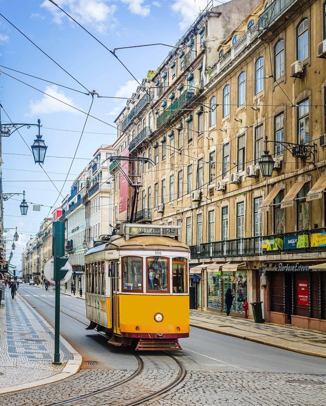 Iconic yellow trams and tiled streets